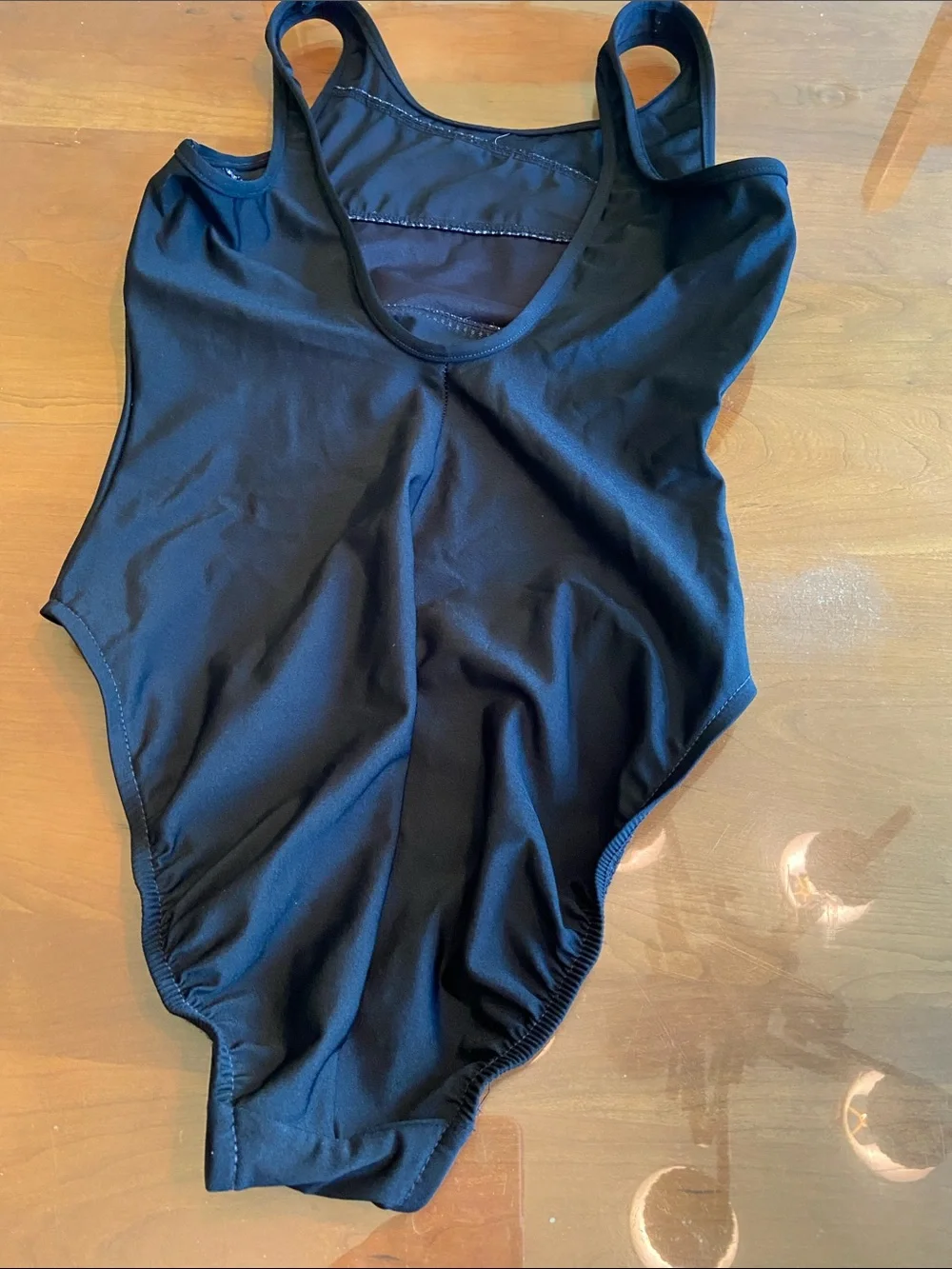 Miracle suit.  One-Piece Swimsuit with Subtle Dot Trim and Criss-Cross front. 10